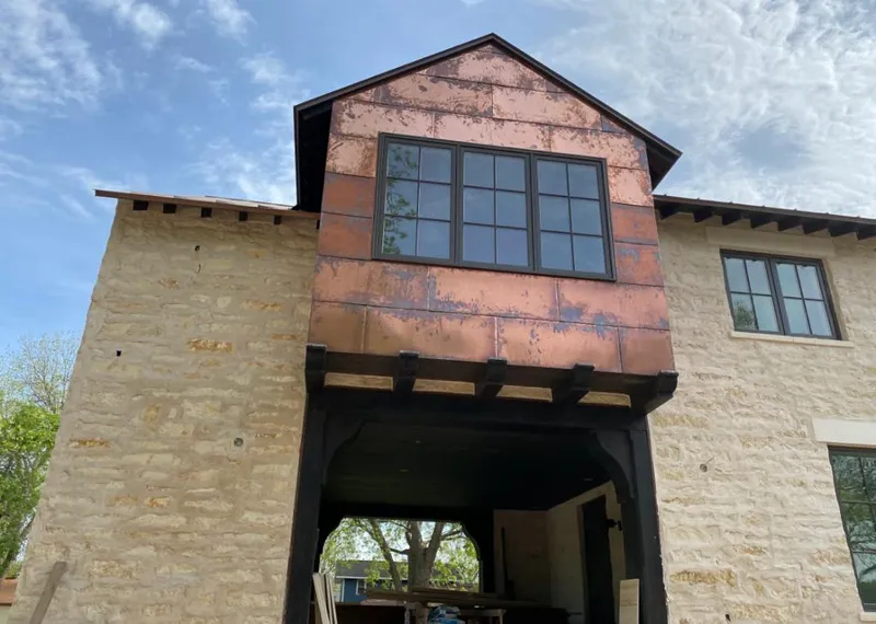 Copper metal panel facade on a stone building for Skylight Installation in Kahaluu